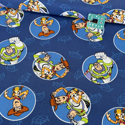 Toy Story Buzz and Woody Badges (Blue) Fabric by Springs Creative